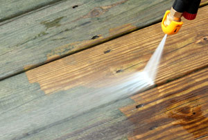 closeup of a deck being power washed